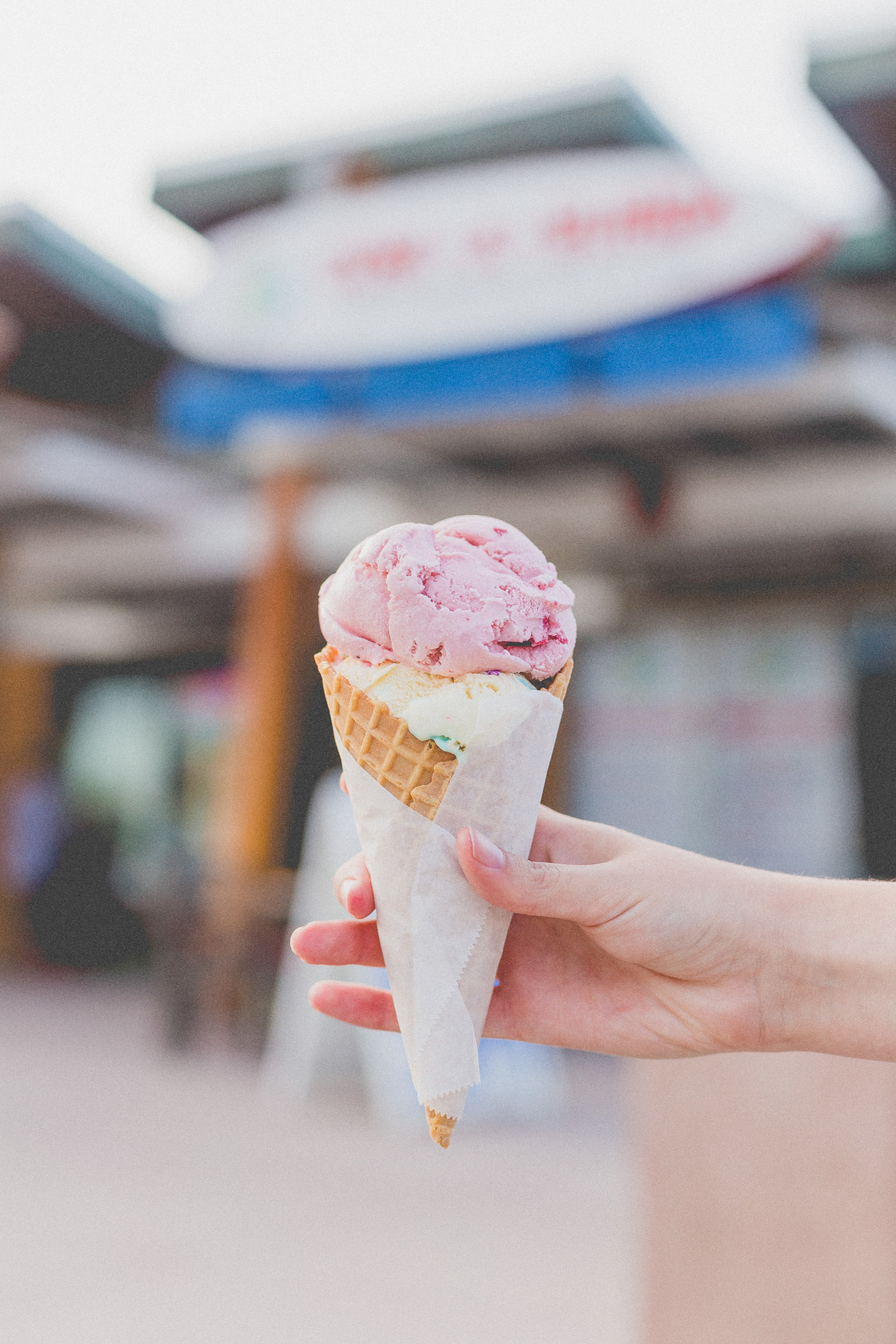ice cream cone being held in a hand. showing how a lack of willpower isn't the problem