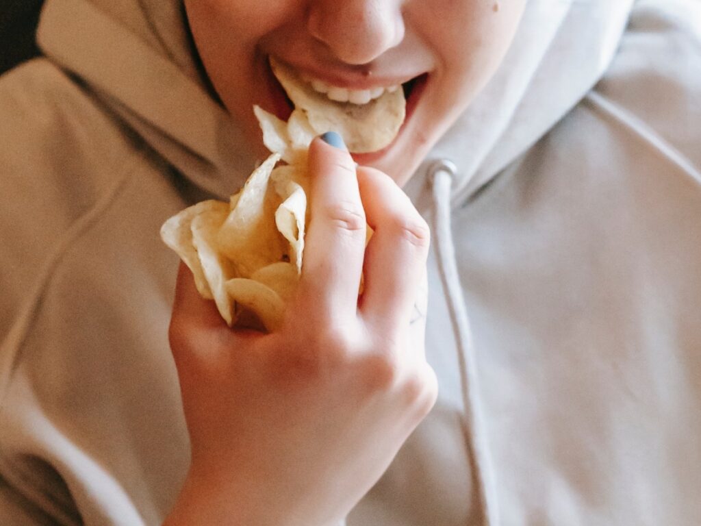 woman binge eating chips - what is binge eating?