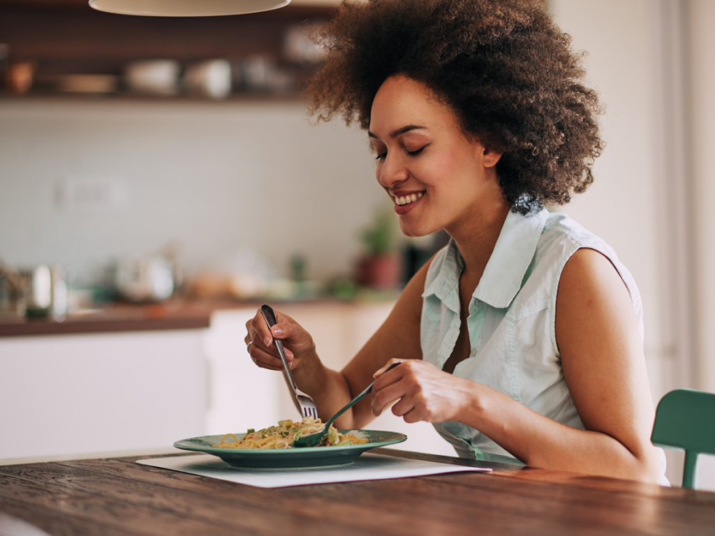 woman eating a meal to nourish her body consistently