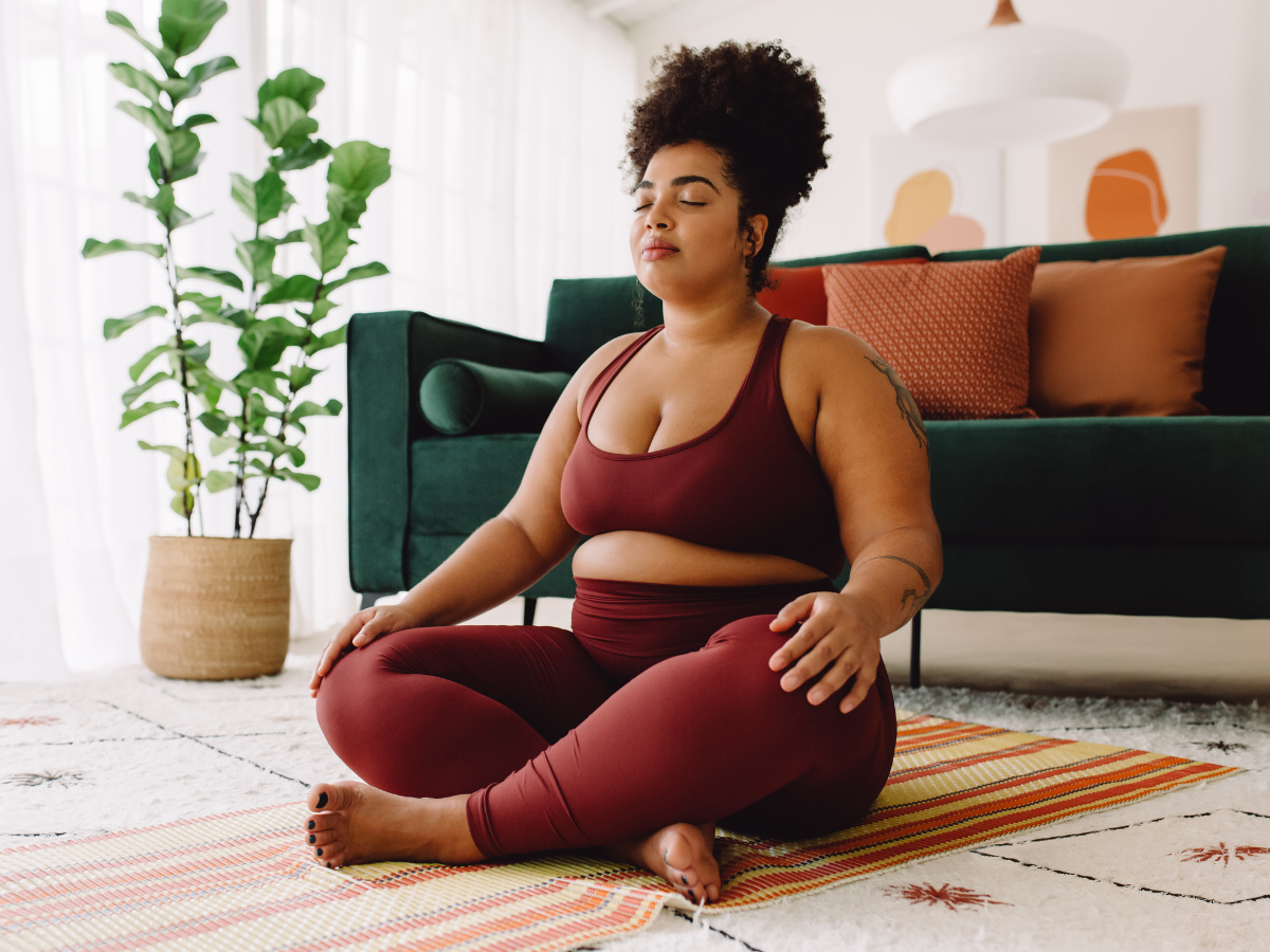 woman sitting cross legged learning how to feel good in your body while finding food freedom