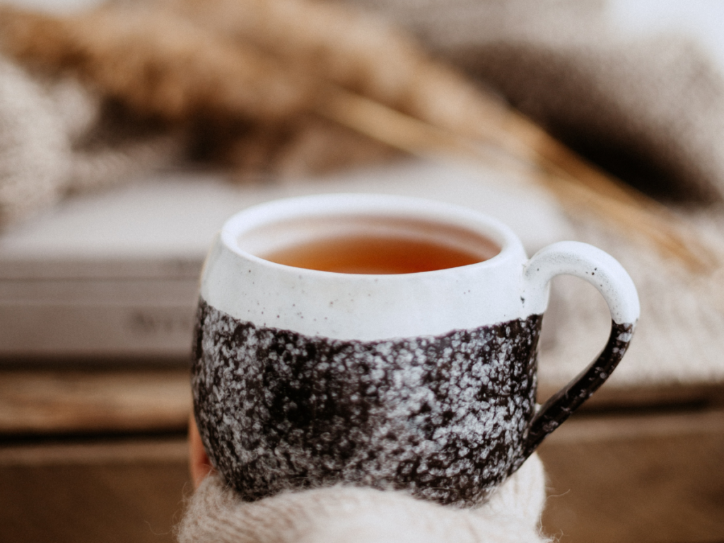 Holding a cozy cup of tea learning how to forgive yourself after binge eating