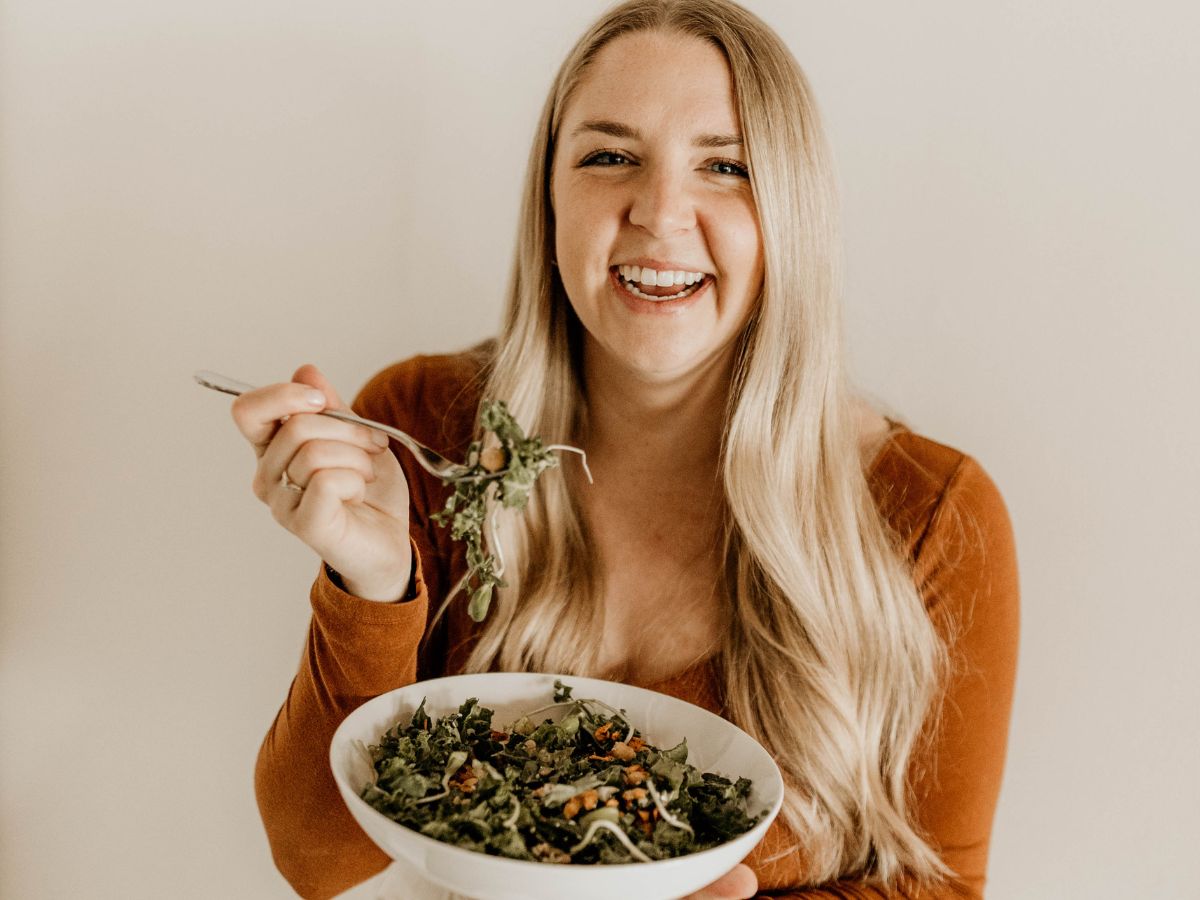 Jenn of The Intuitive Nutritionist holding a bowl of salad answering the question can I crave vegetables?